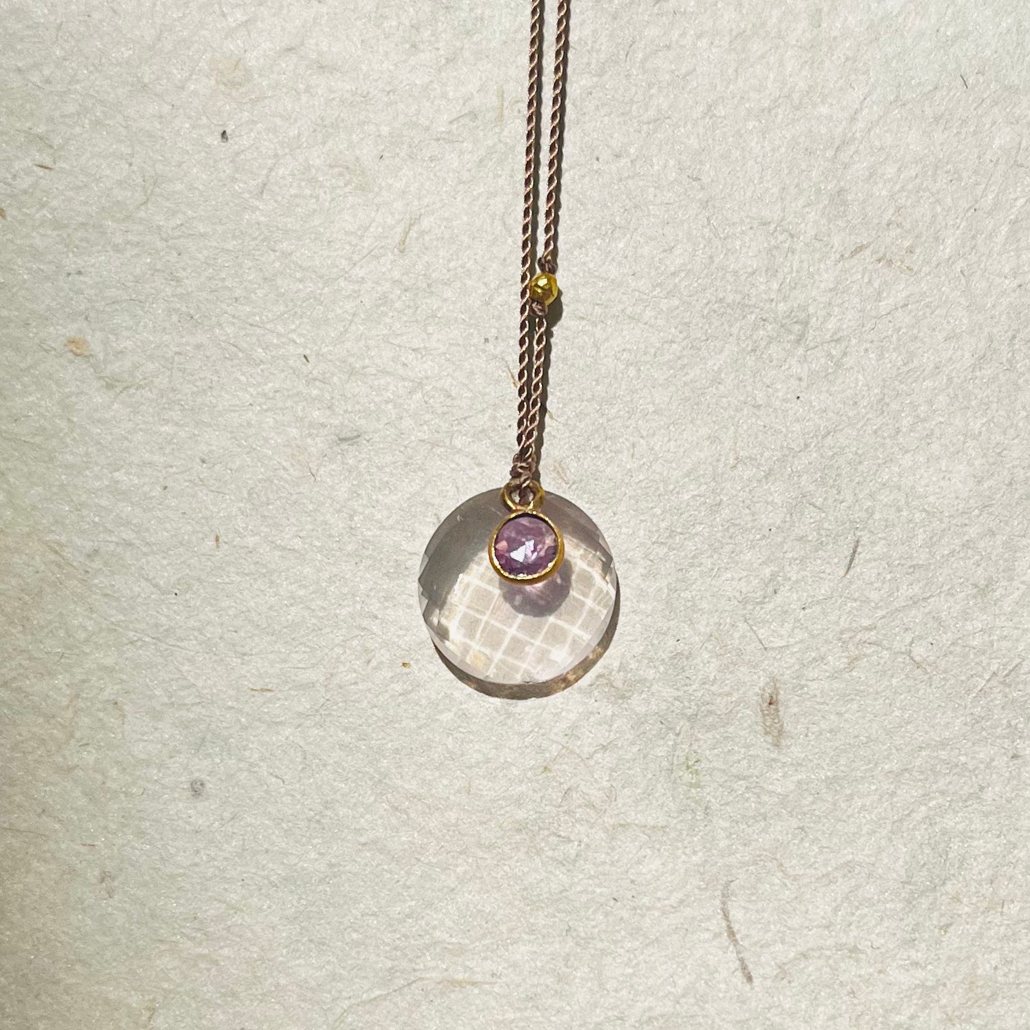Rose quartz disc pendant with small pink sapphire accent on bronze chain necklace