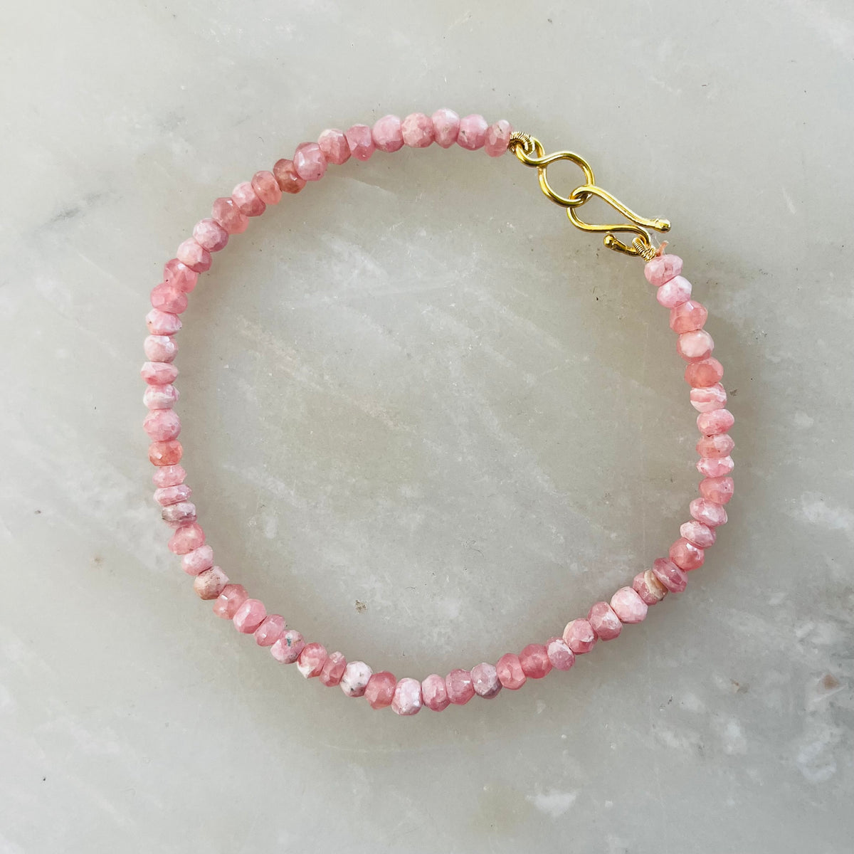 Rhodochrosite bracelet with faceted pink beads and gold-tone hook clasp