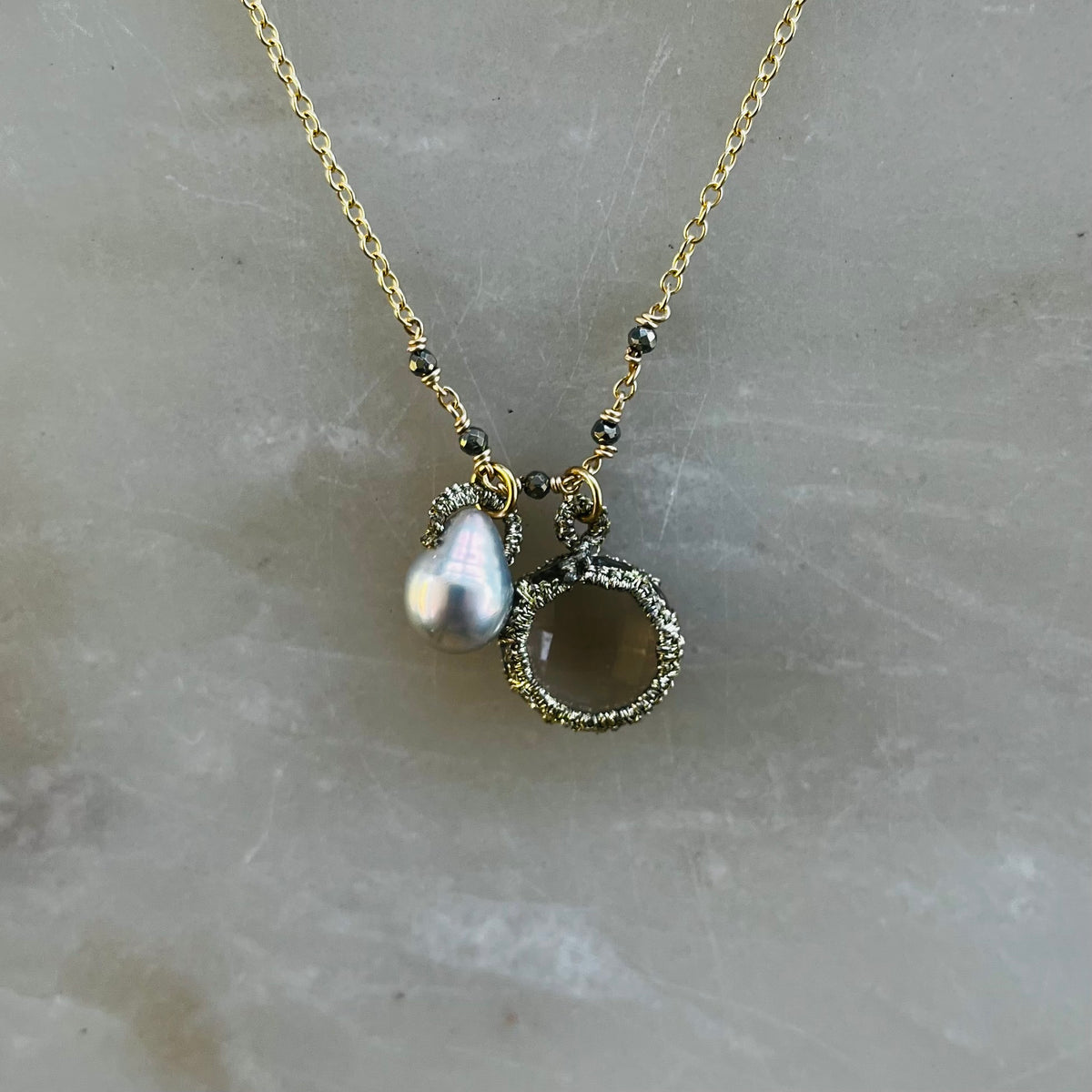 Toi et moi necklace with teardrop pearl and circular pendant on gold chain