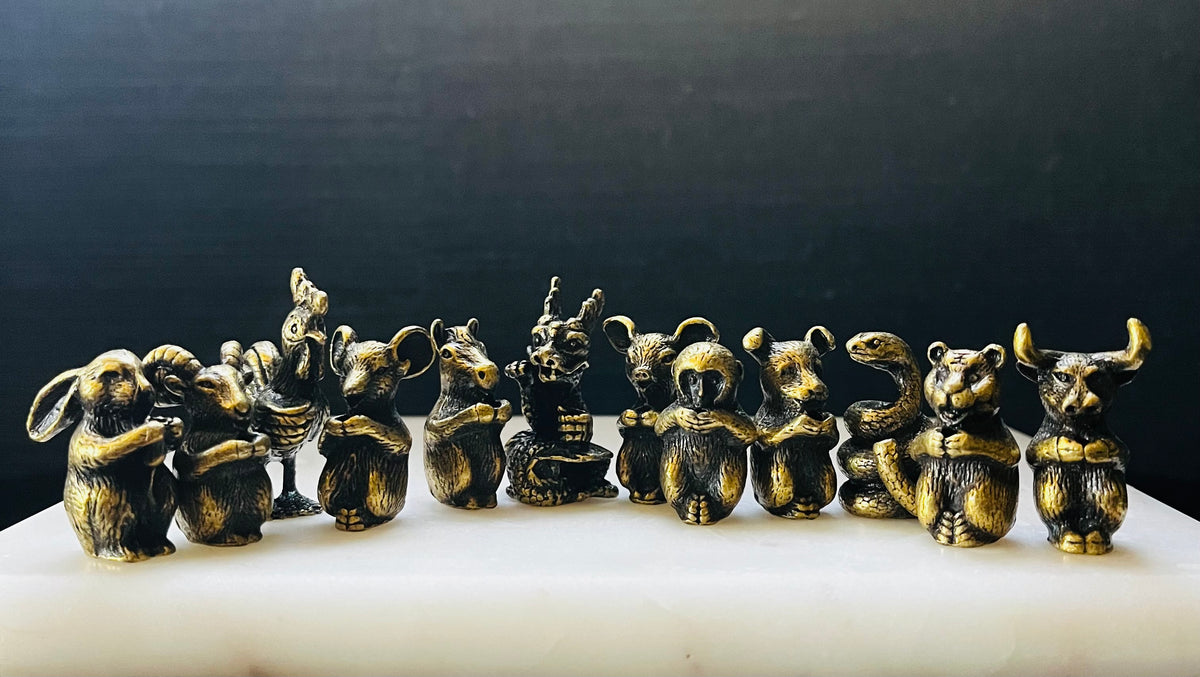 Twelve small bronze animal figurines representing the Chinese zodiac arranged in a row