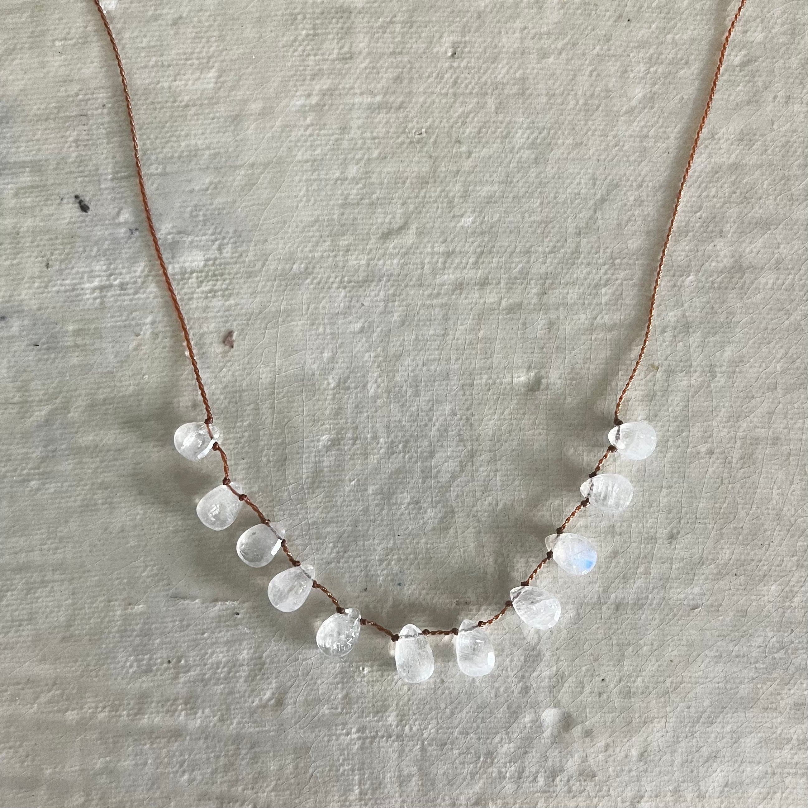 Delicate necklace with translucent moonstone briolette drops strung on thin brown cord