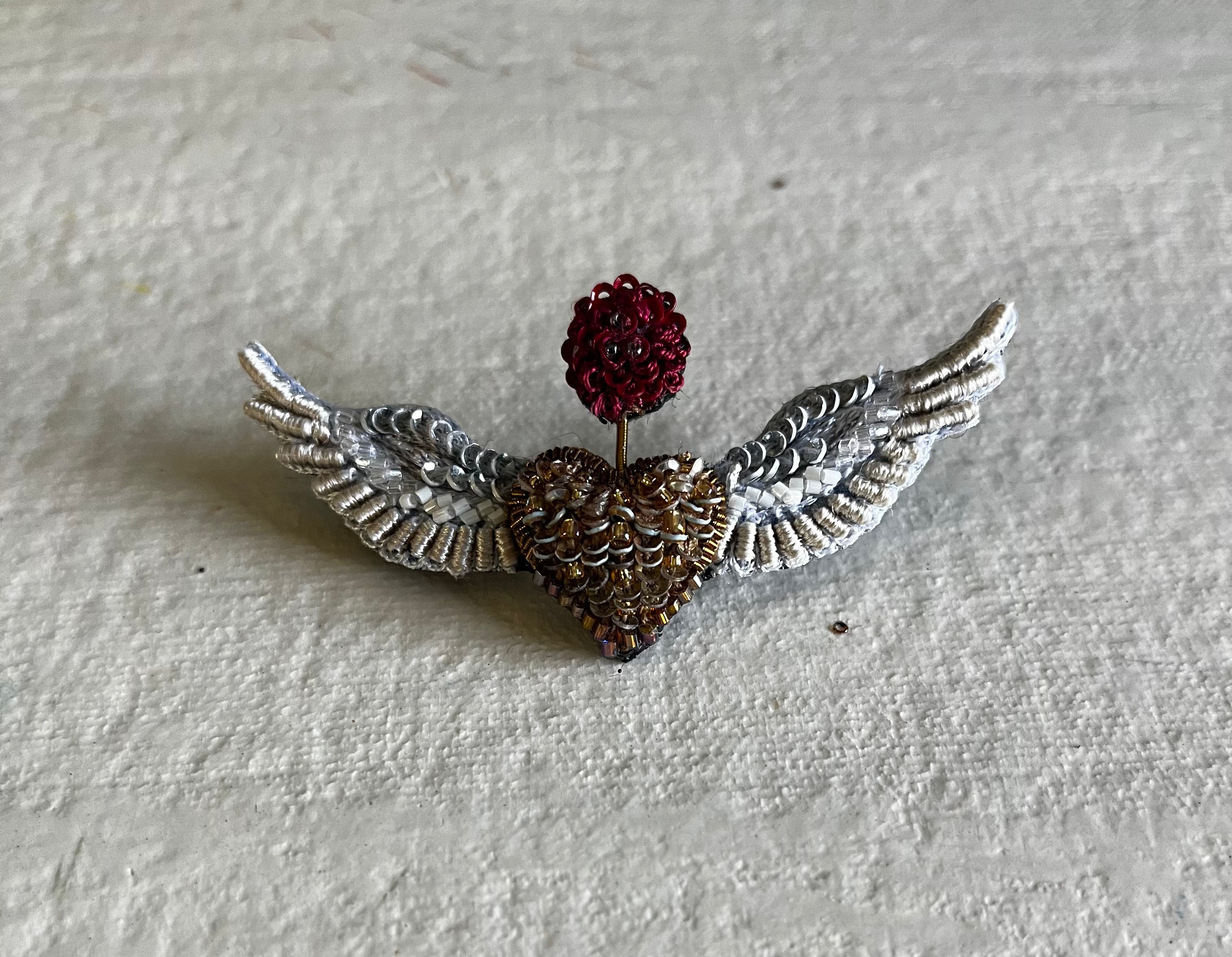 Flying Angel Brooch with silver wings, bronze textured heart, and red crystal crown