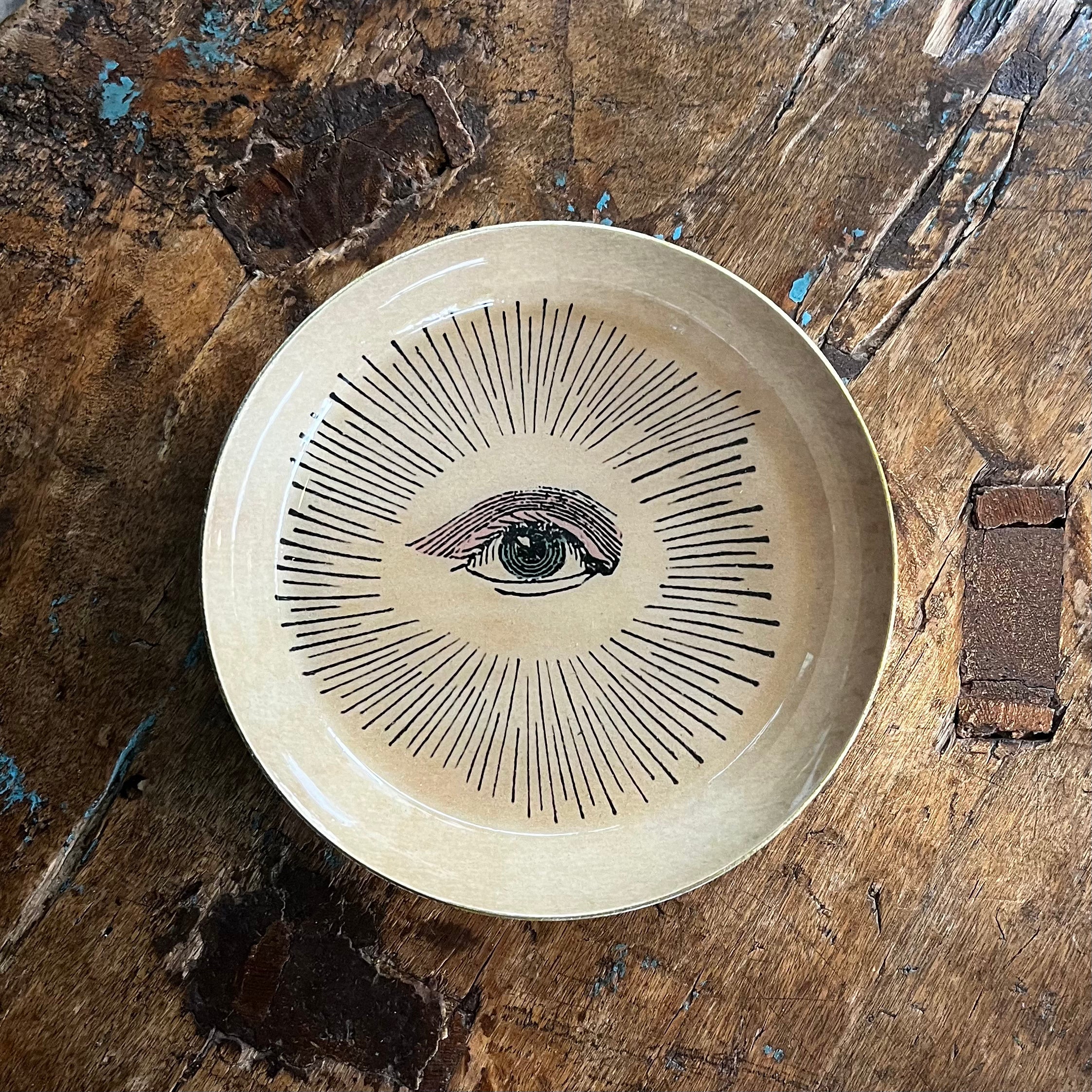 Ceramic EYE tray with black eye illustration and radiating lines on cream glaze