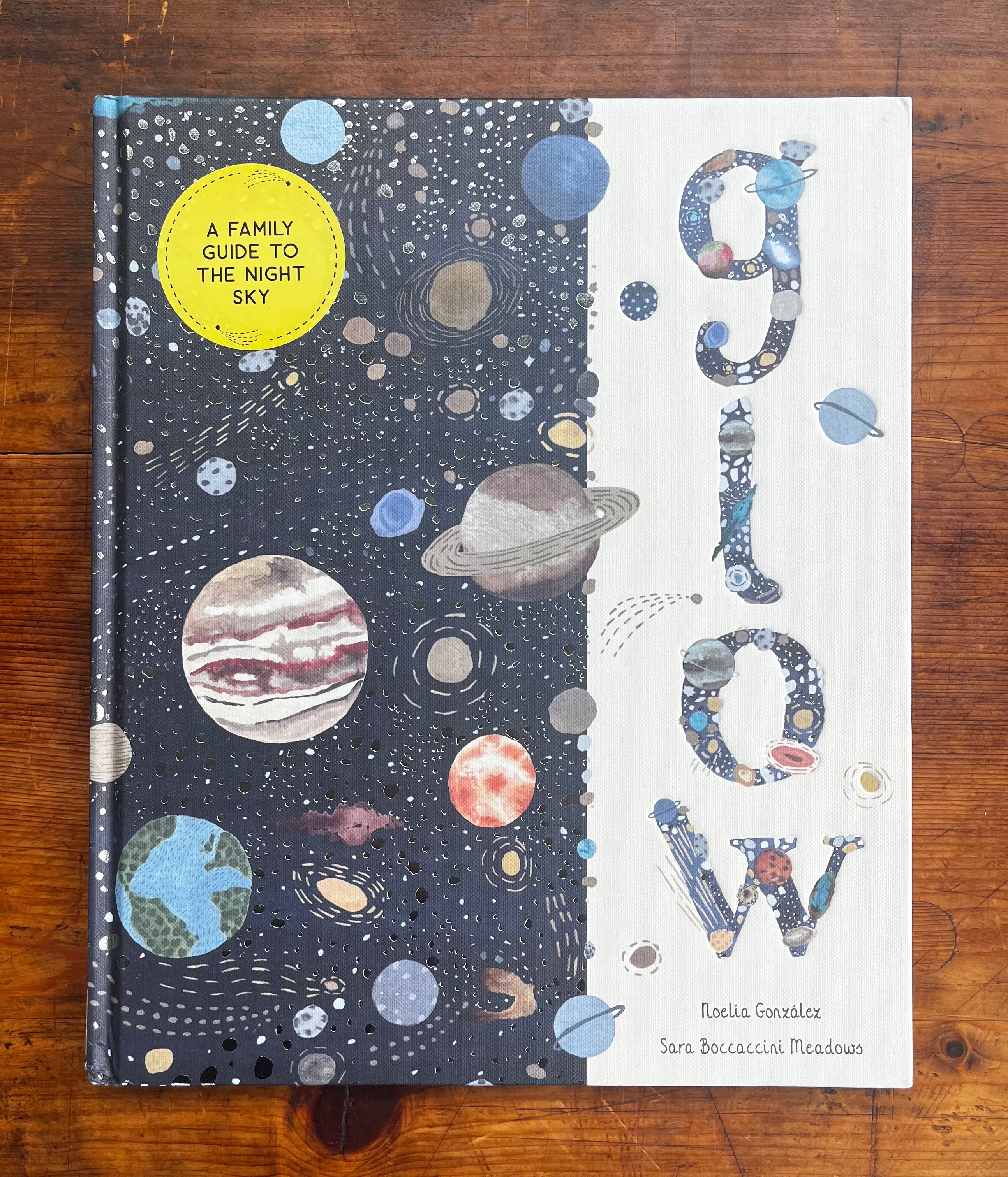 Glow book cover showing night sky with planets on left, decorative title letters on right