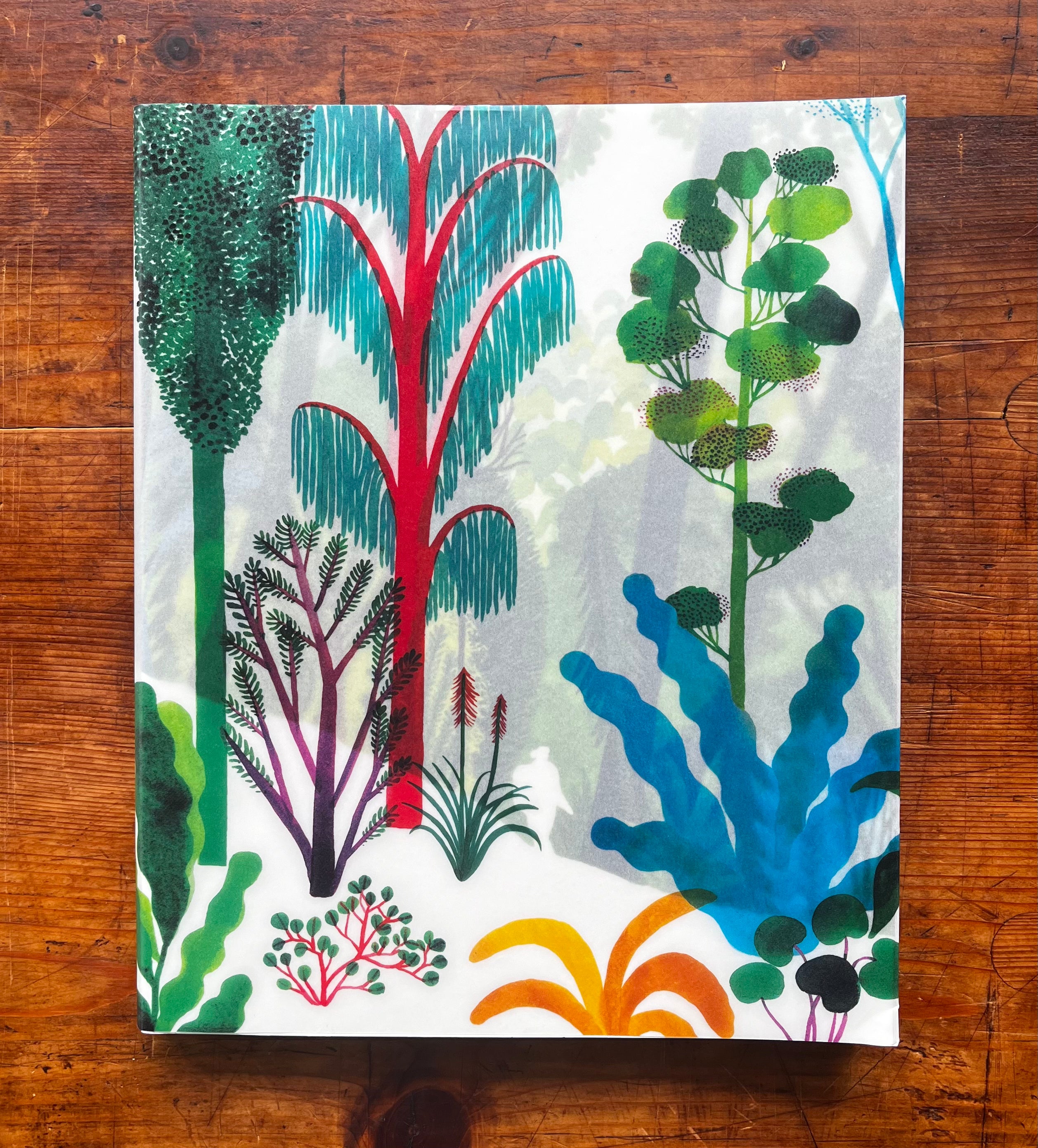 The Forest Book with colorful illustrated cover showing stylized trees and plants in greens, blues, reds, and orange