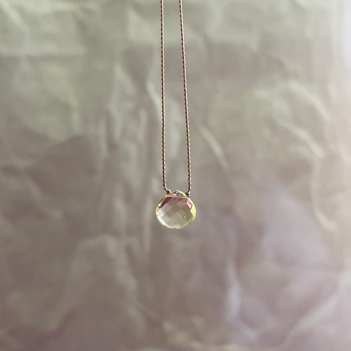 Citrine necklace with faceted yellow gemstone pendant on delicate gold chain