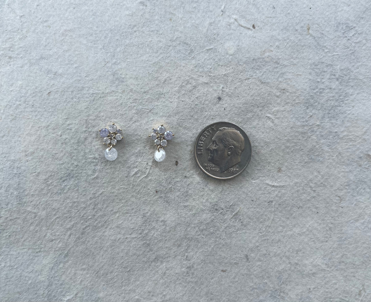 Lavender ombre flower stud earrings with dangling crystals next to dime for scale