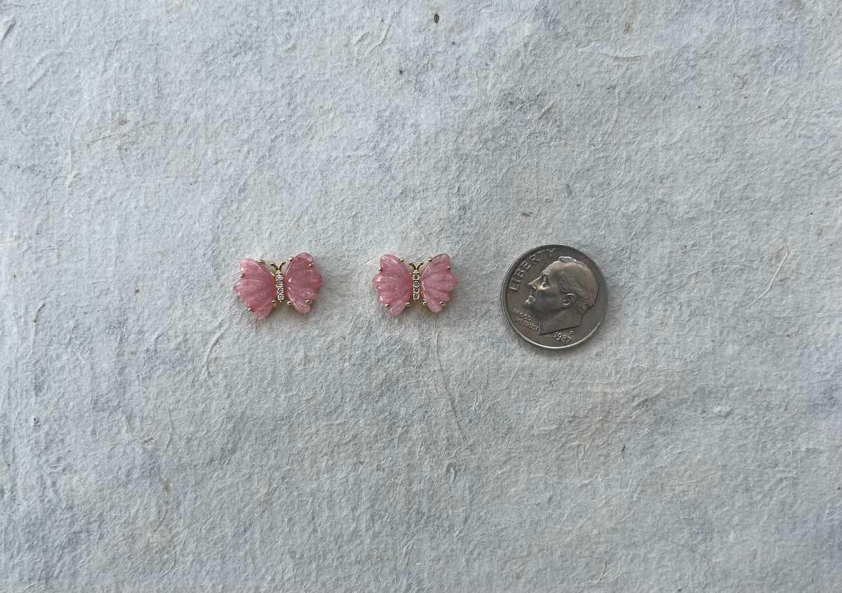 Pair of pink rose quartz butterfly stud earrings next to dime for size