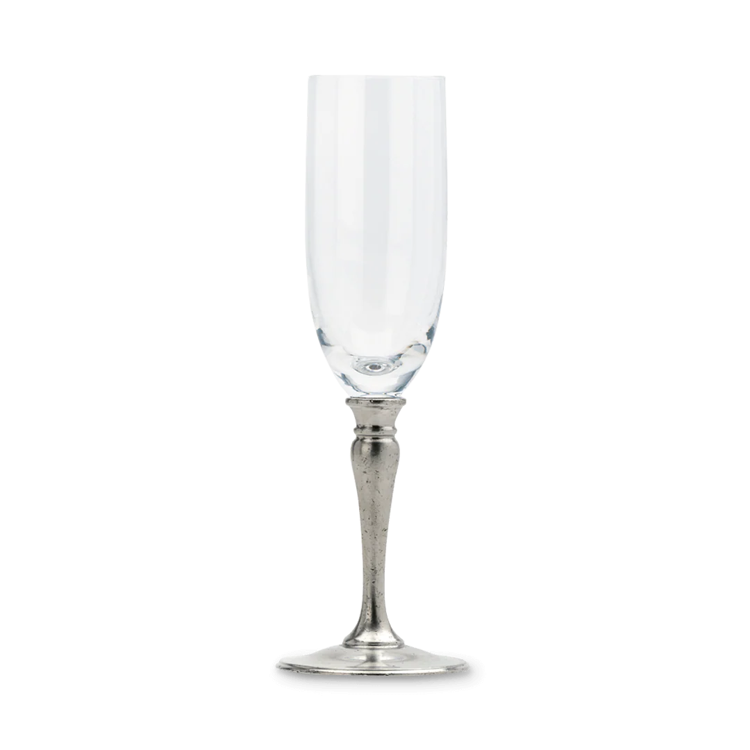 Champagne glass with clear bowl and silver-toned pewter stem on white background